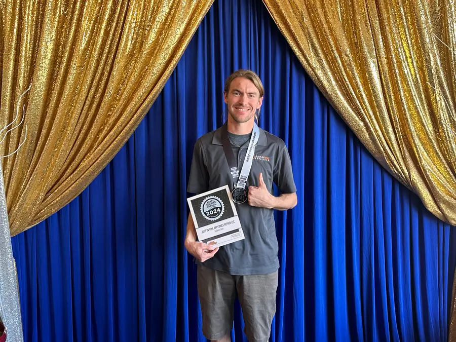 Just-in Time team member holding Best of Southern Oregon 2024 award and medal