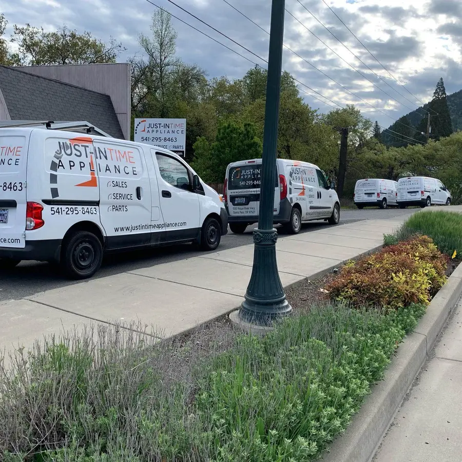 Just-in Time Appliance Repair fleet of service vans lined up on the street