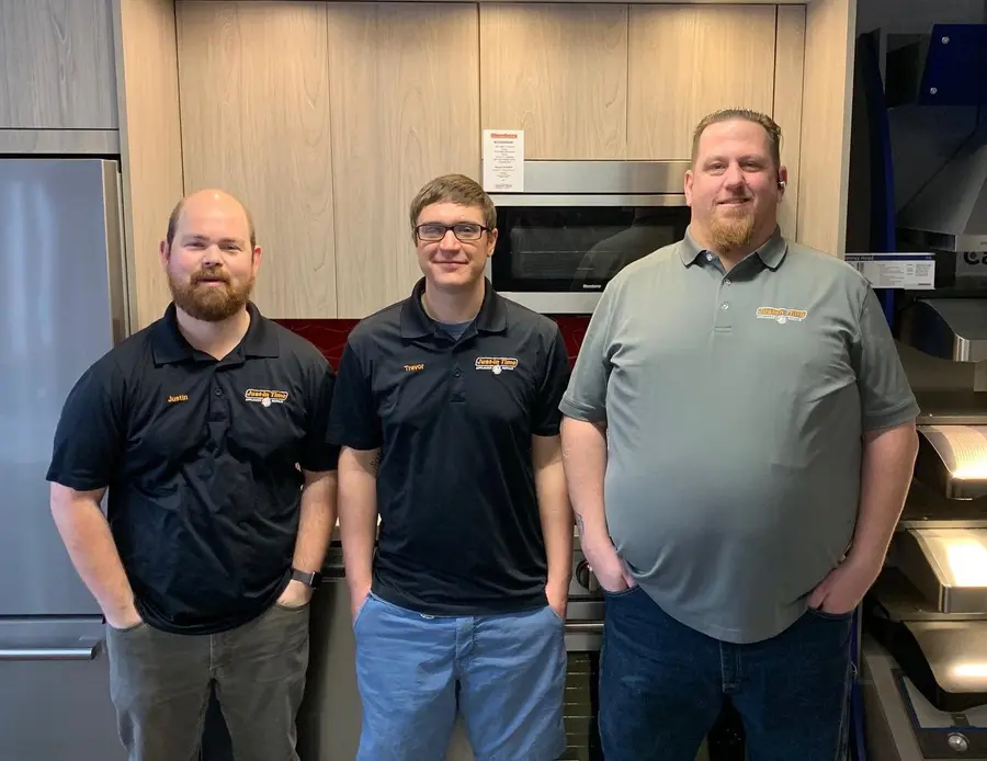 Three Just-in Time Appliance Repair team members in uniform