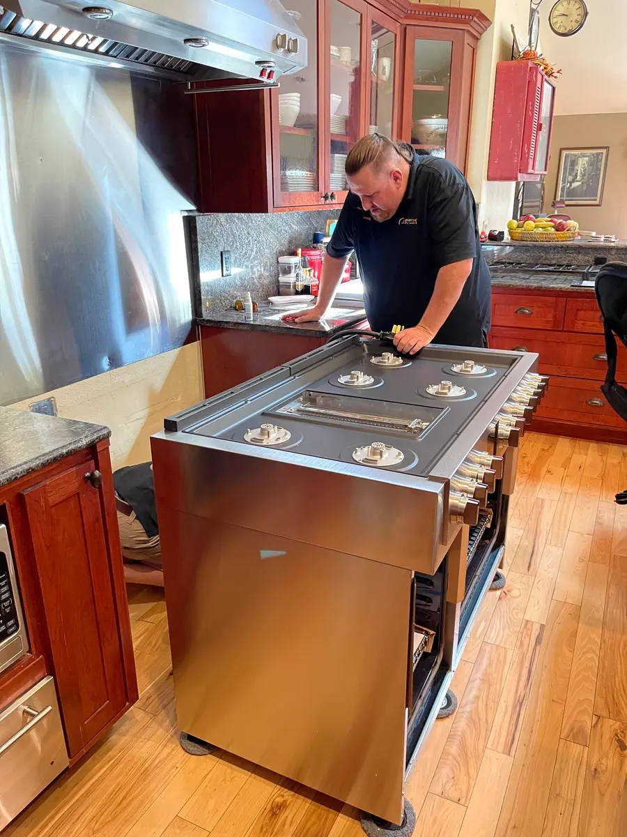 Technician servicing a luxury cooktop