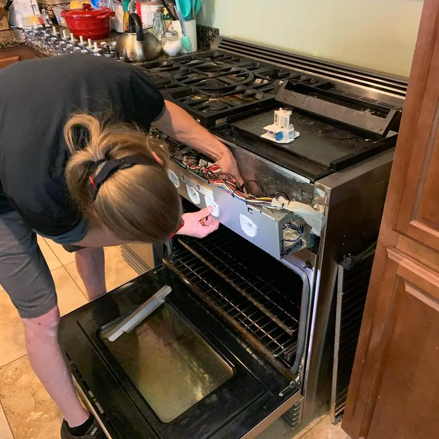 Technician repairing an oven