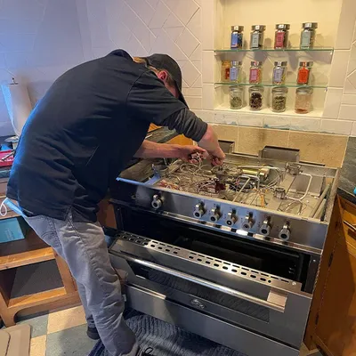 Technician servicing a high-end range