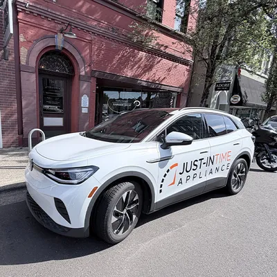 Just-in Time branded SUV parked downtown