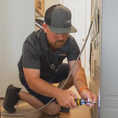 Technician servicing a refrigerator