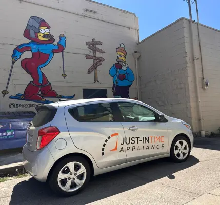 Just-in Time branded vehicle in front of Oregon street mural