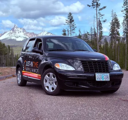 Just-in Time black PT Cruiser with Mt. Thielsen backdrop